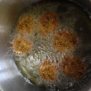 Turn falafel to finish frying